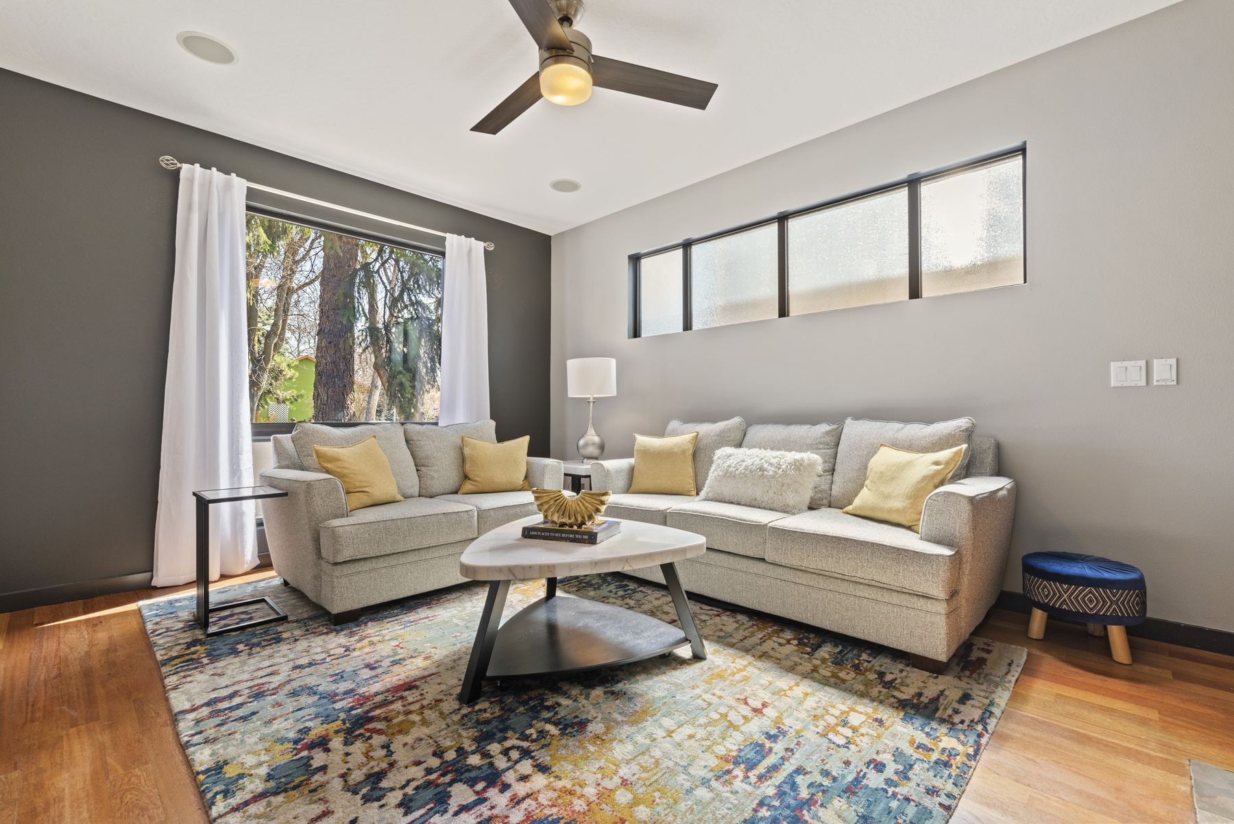 Open plan living room with sectional sofa and clerestory windows, North End Boise rental